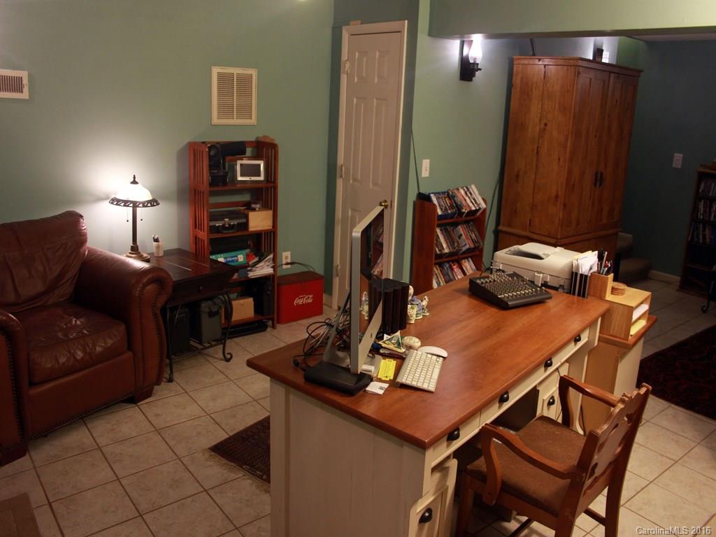 185 Loop Road Clyde, NC 28721 - Photo 8 of 24 a work room with furniture and wooden floor