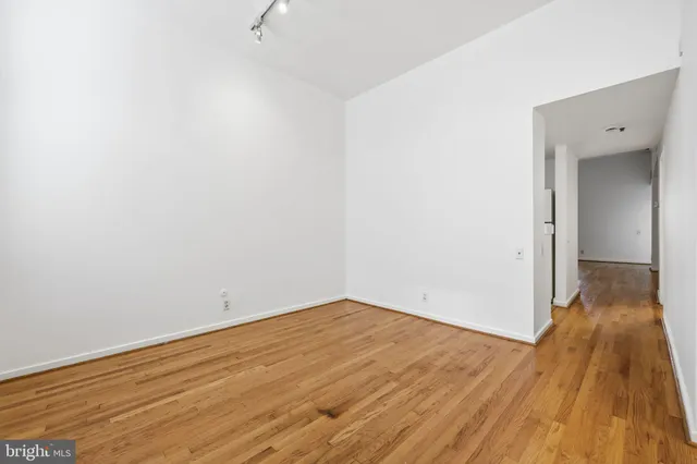 a view of a room with wooden floor
