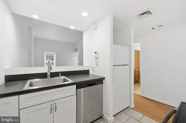 a kitchen with a sink and a refrigerator