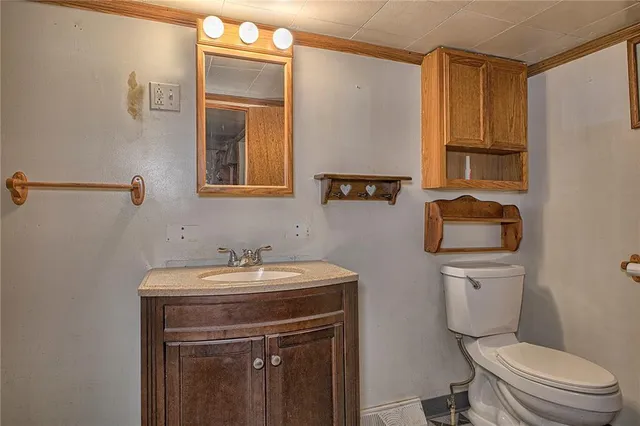 a bathroom with a sink a toilet and a mirror