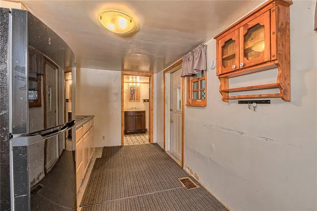 a view of hallway with stairs and wooden floor