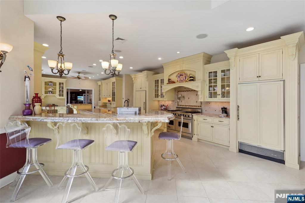 14 Werimus Brook Road Saddle River, NJ 07458 - Photo 15 of 50 a large kitchen with a table and chairs