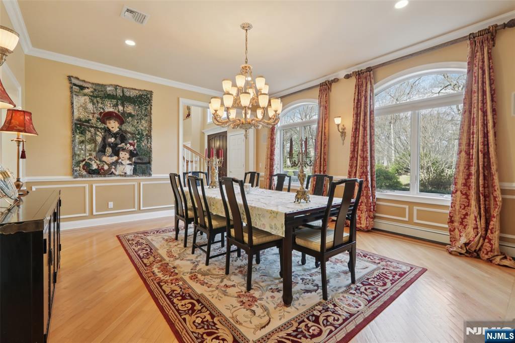 14 Werimus Brook Road Saddle River, NJ 07458 - Photo 18 of 50 a dining room with furniture a rug and a chandelier