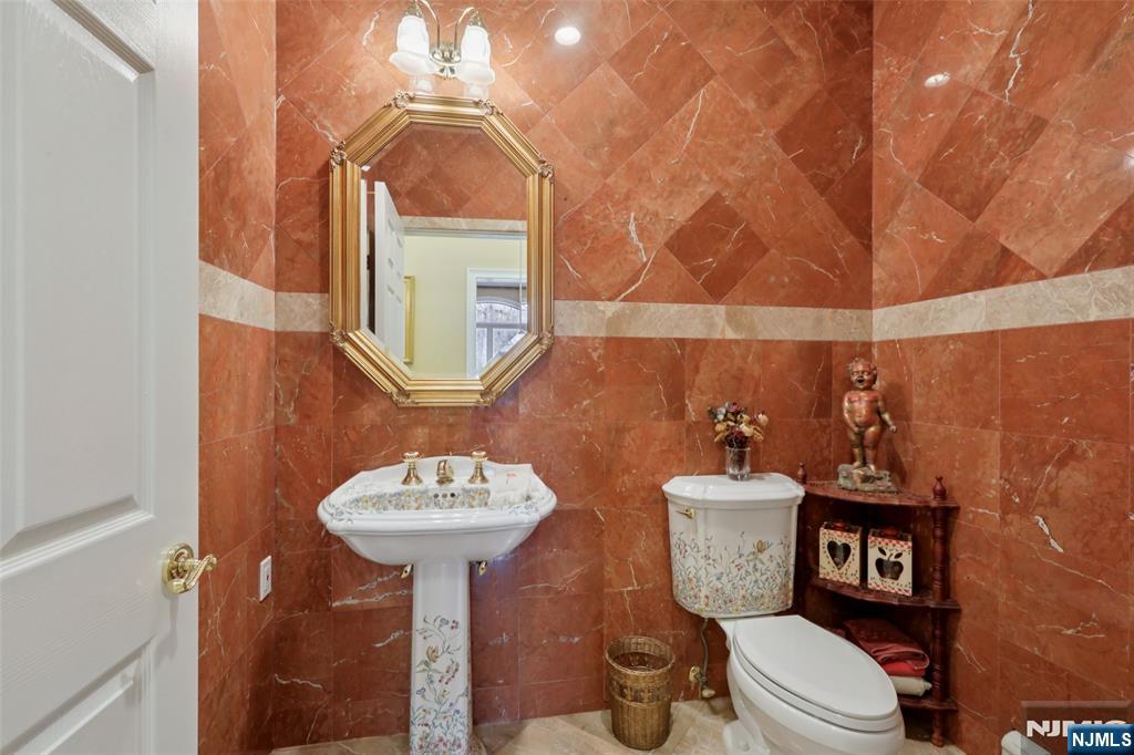 14 Werimus Brook Road Saddle River, NJ 07458 - Photo 22 of 50 a bathroom with a toilet a sink and mirror