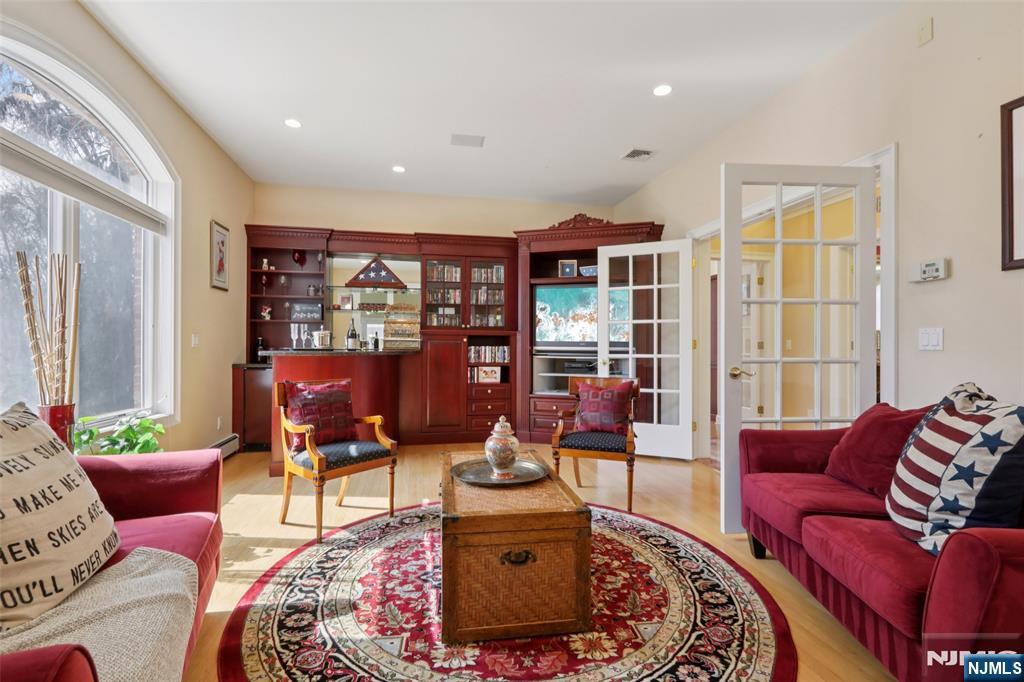 14 Werimus Brook Road Saddle River, NJ 07458 - Photo 25 of 50 a living room with furniture and a floor to ceiling window