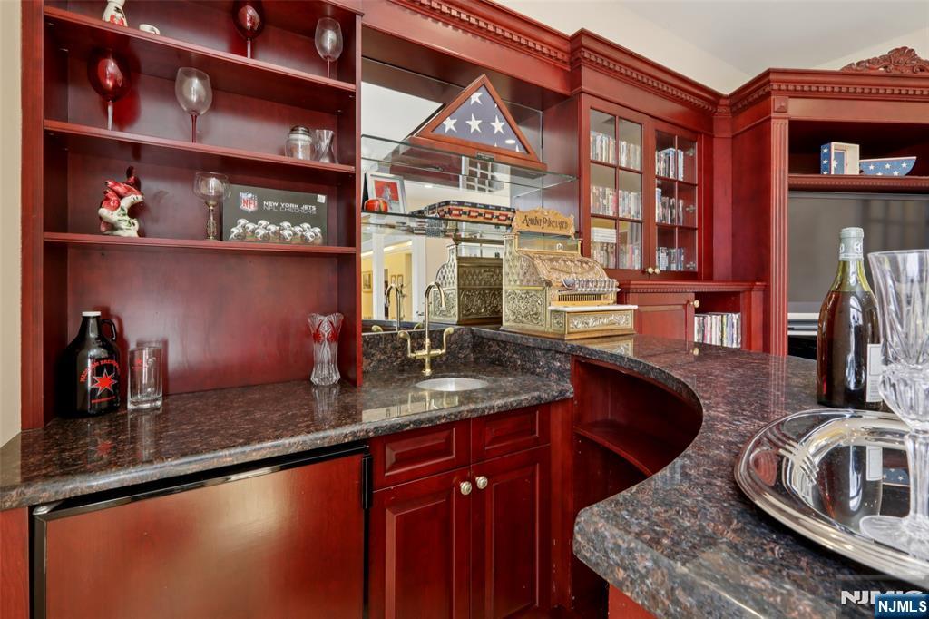 14 Werimus Brook Road Saddle River, NJ 07458 - Photo 26 of 50 a kitchen with stainless steel appliances granite countertop a sink stove and cabinets