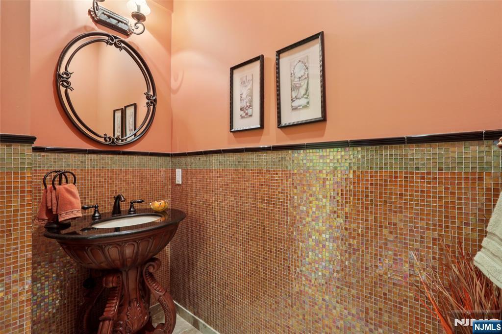 14 Werimus Brook Road Saddle River, NJ 07458 - Photo 28 of 50 a bathroom with a sink a mirror and a shower