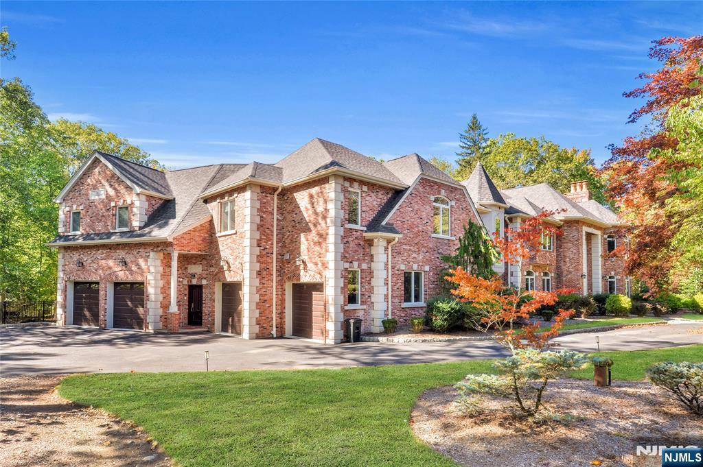 14 Werimus Brook Road Saddle River, NJ 07458 - Photo 3 of 50 front view of a building with a garden
