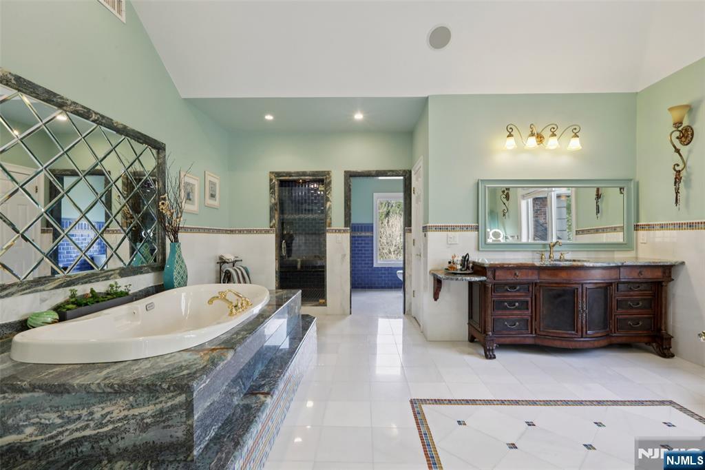 14 Werimus Brook Road Saddle River, NJ 07458 - Photo 37 of 50 a spacious bathroom with a tub sink and mirror
