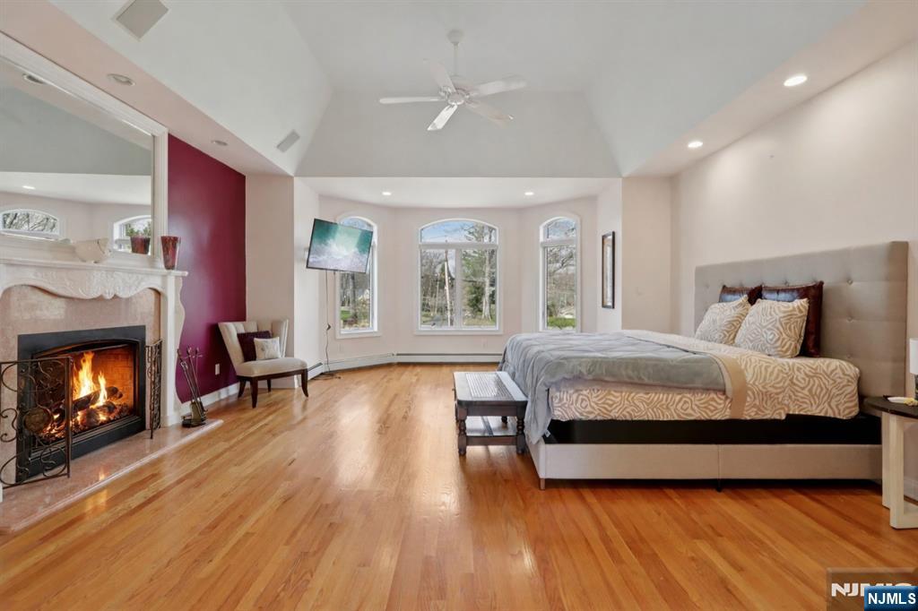 14 Werimus Brook Road Saddle River, NJ 07458 - Photo 38 of 50 a bedroom with a bed and a fireplace