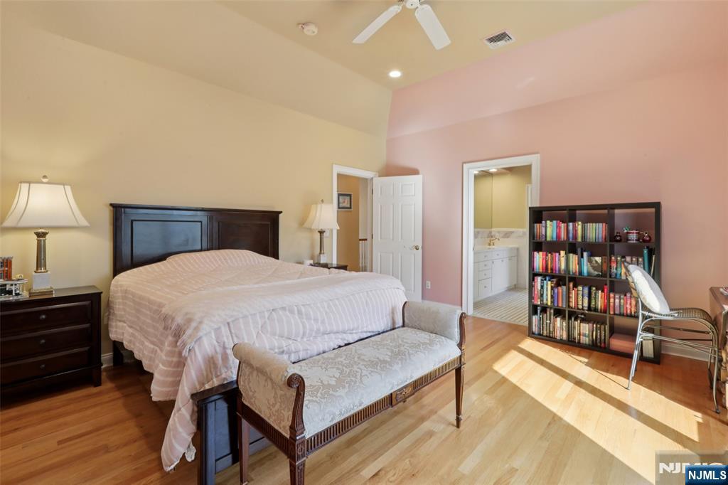 14 Werimus Brook Road Saddle River, NJ 07458 - Photo 41 of 50 a spacious bedroom with a bed a dresser and wooden floor