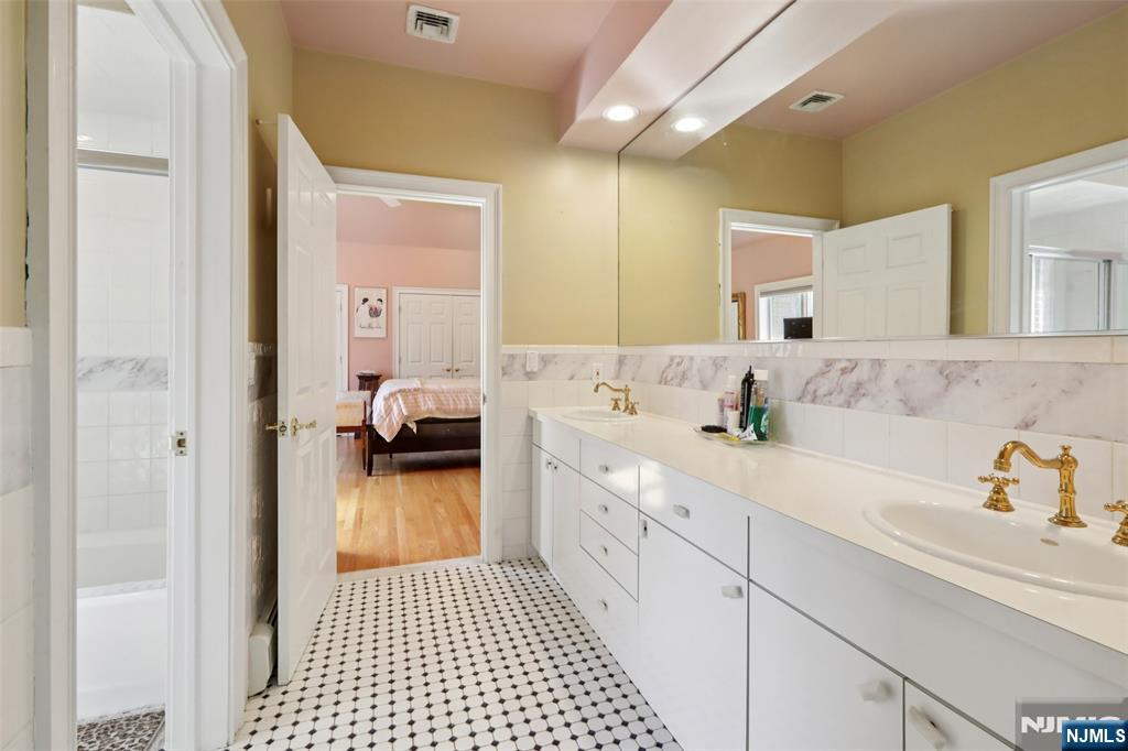 14 Werimus Brook Road Saddle River, NJ 07458 - Photo 42 of 50 a en suite bathroom with a sink and a mirror