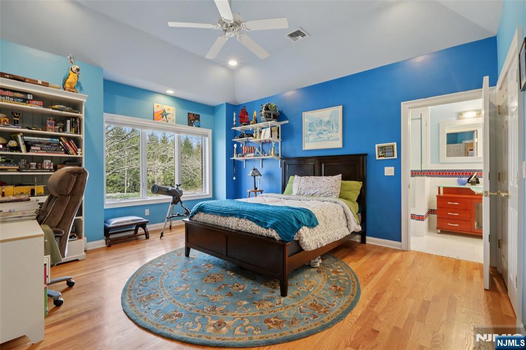14 Werimus Brook Road Saddle River, NJ 07458 - Photo 43 of 50 a bedroom with a bed a dresser and book shelfs