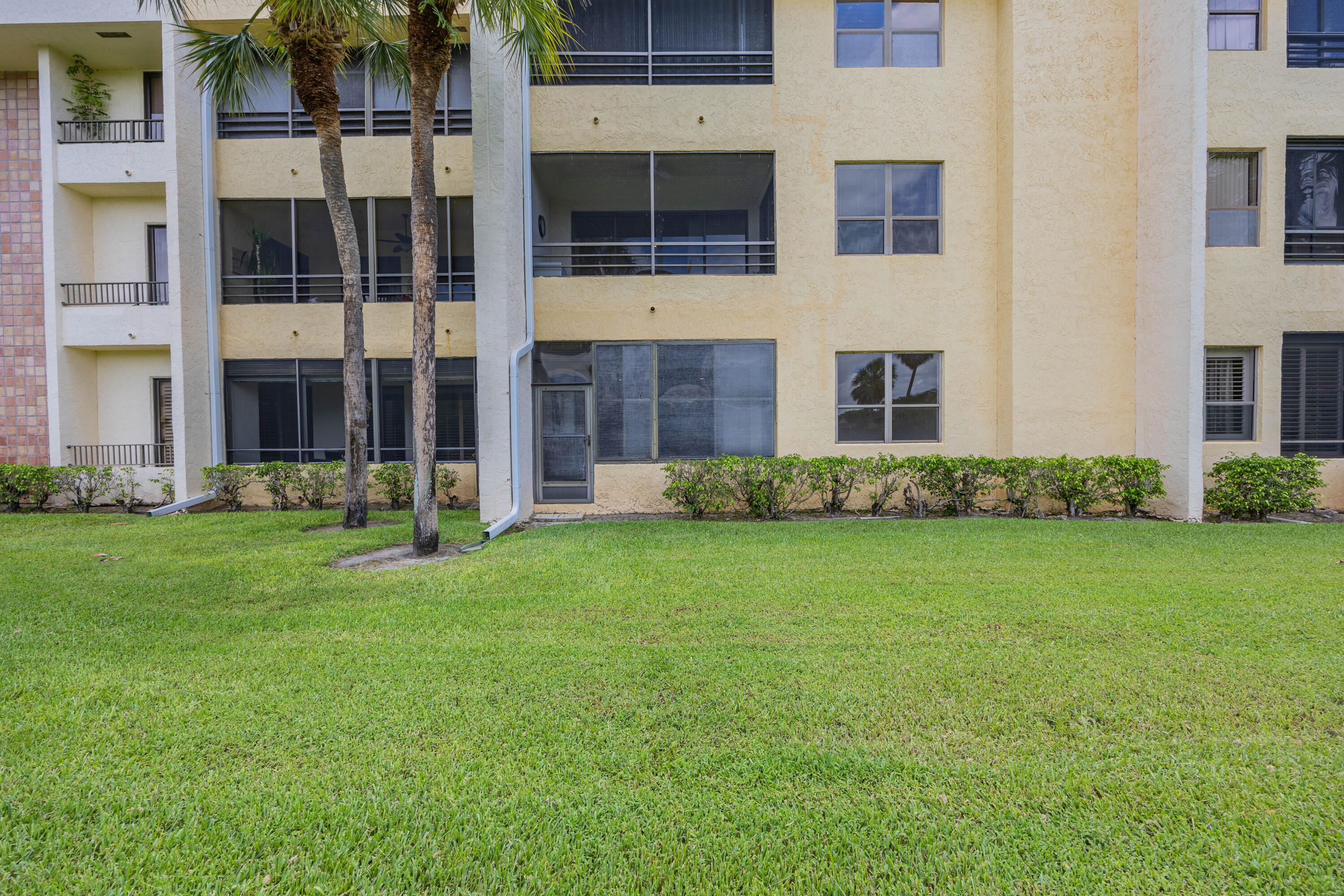 7520 La Paz Boulevard, Unit 104 Boca Raton, FL 33433 - Photo 56 of 56 a view of a building with a yard