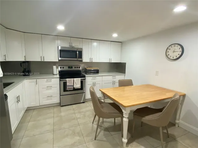a kitchen with a stove a sink and a refrigerator
