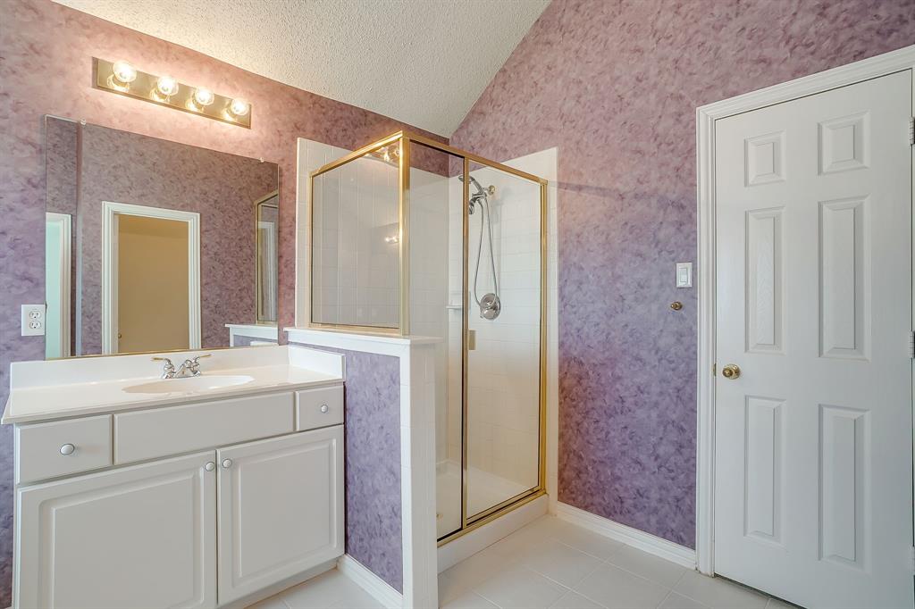 8105 Hosta Way Fort Worth, TX 76123 - Photo 24 of 33 a bathroom with a double vanity sink mirror and shower