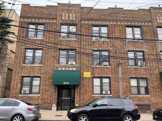 a front view of a house with car parked