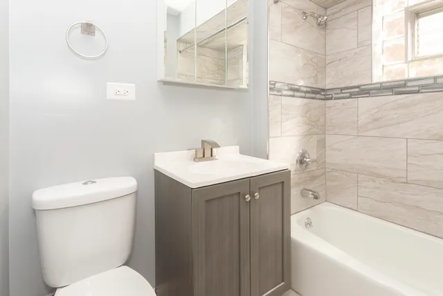 a bathroom with a sink a toilet and bathtub