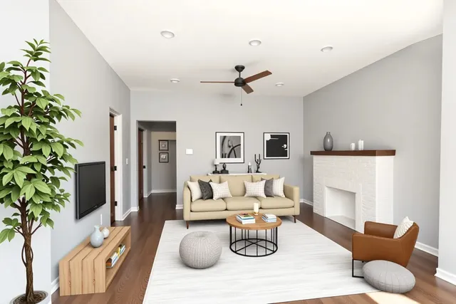 a living room with furniture a fireplace and a potted plant