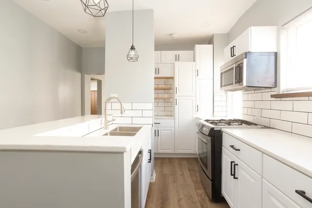 a kitchen with a sink stove and refrigerator
