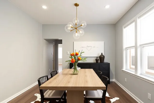 a view of a dining room with furniture a chandelier and wooden floor