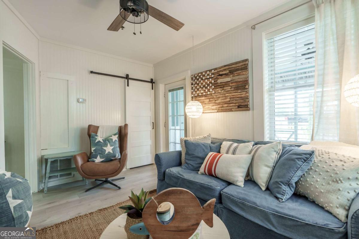 1413 2nd Avenue, Unit 4 Tybee Island, GA 31328 - Photo 11 of 32 a living room with furniture and a window