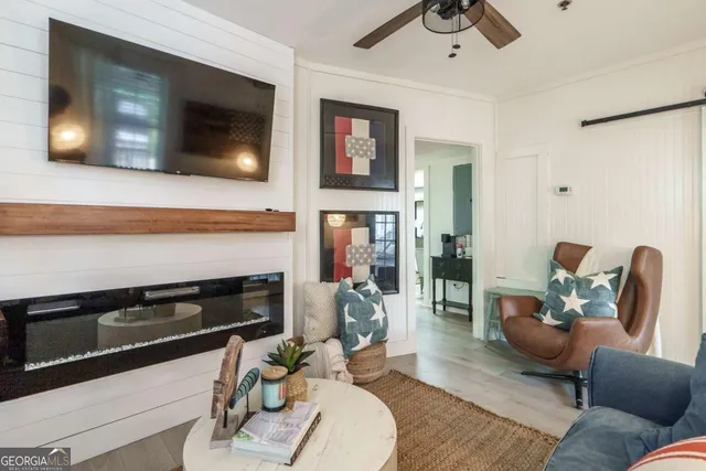 a living room with furniture and a flat screen tv