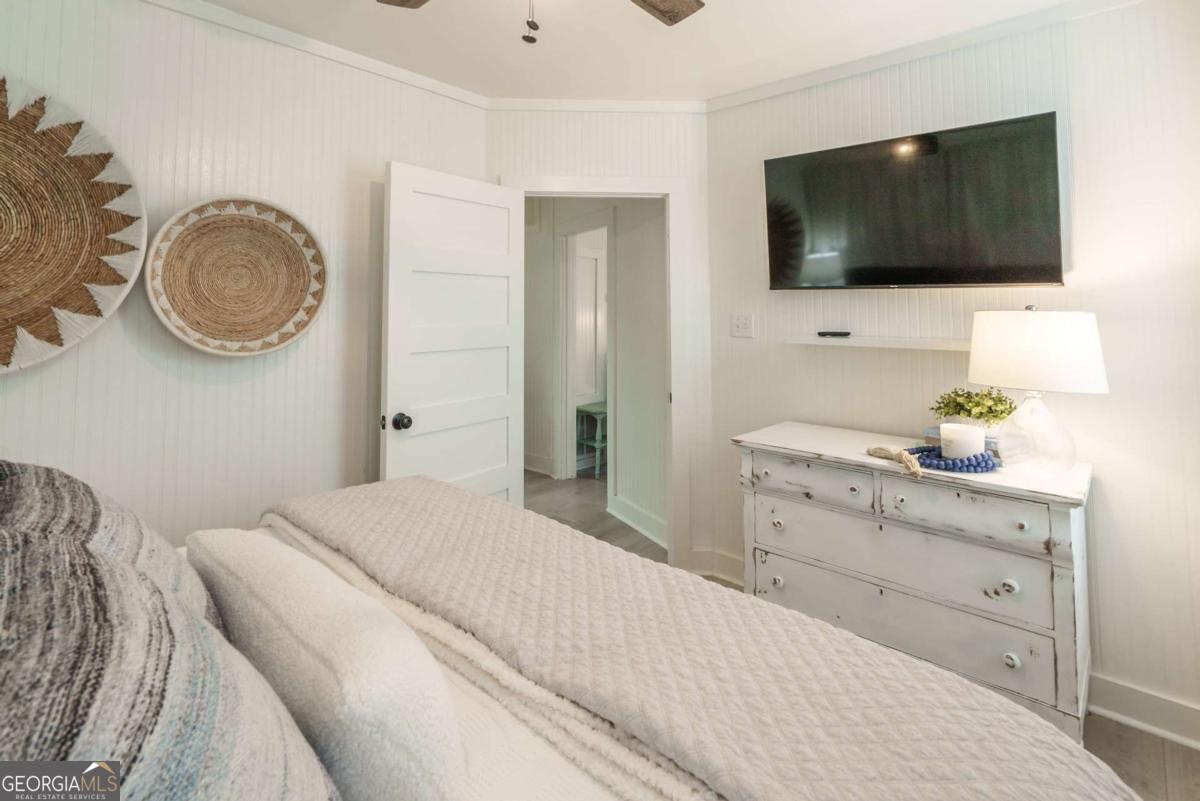 1413 2nd Avenue, Unit 4 Tybee Island, GA 31328 - Photo 15 of 32 a bedroom with a bed and a flat screen tv