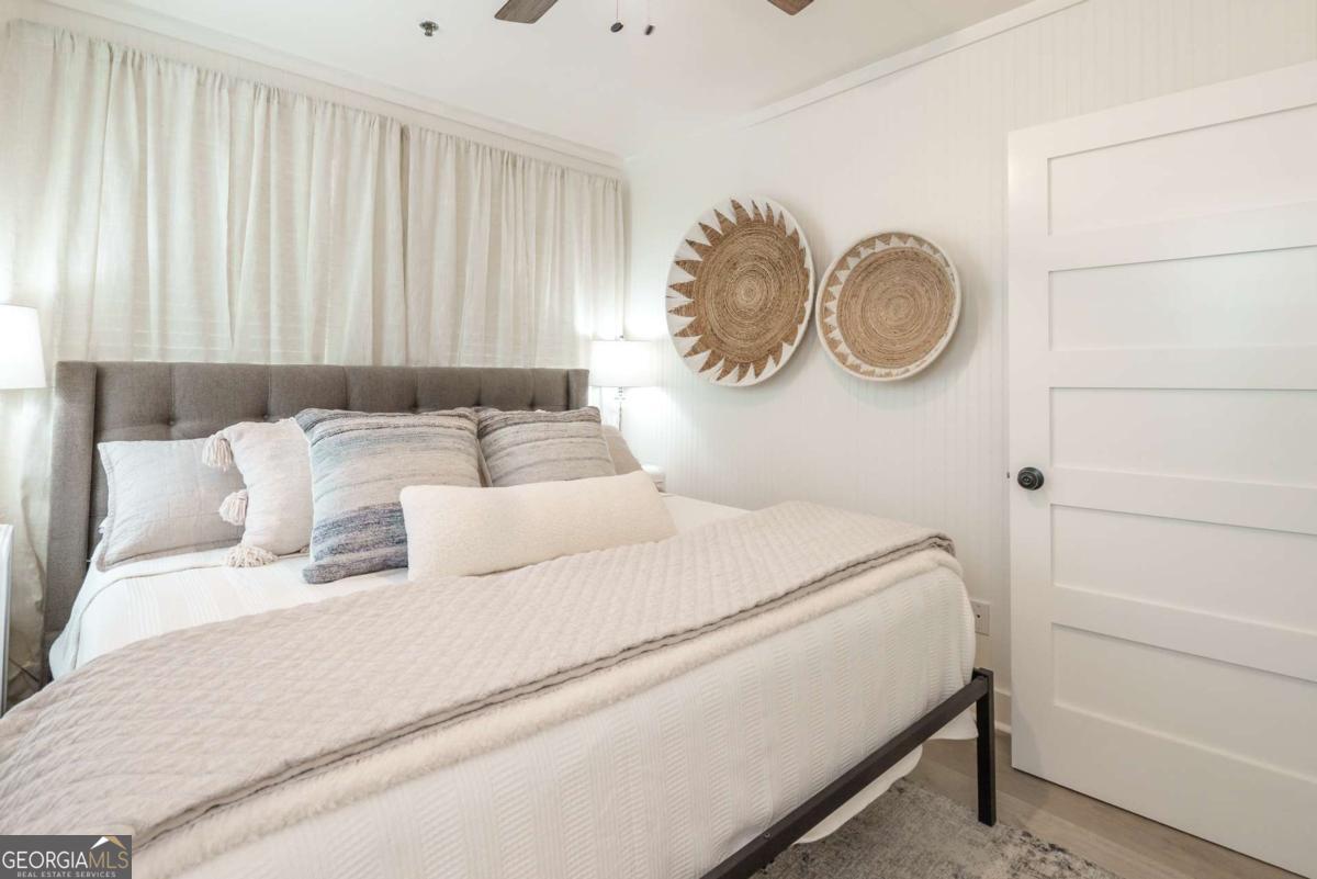 1413 2nd Avenue, Unit 4 Tybee Island, GA 31328 - Photo 16 of 32 a bedroom with a bed and a chair