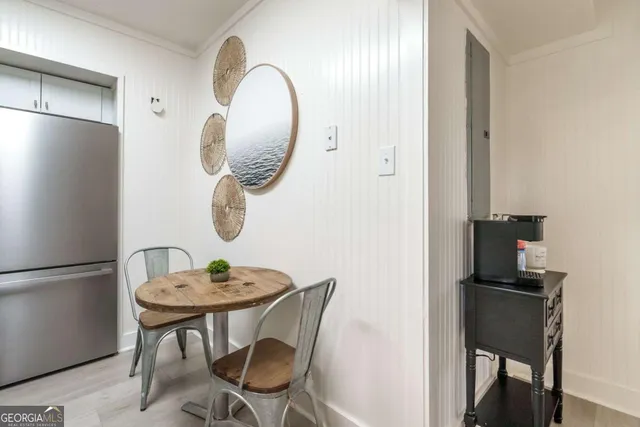 a dining room with furniture and mirror