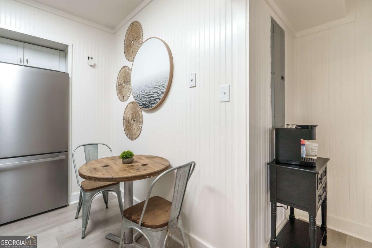 1413 2nd Avenue, Unit 4 Tybee Island, GA 31328 - Photo 17 of 32 a dining room with furniture and mirror