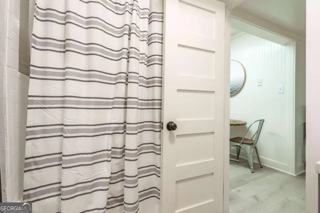 a bathroom with a shower curtain and a sink