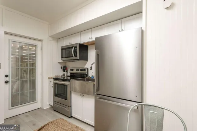 a kitchen with stainless steel appliances granite countertop a refrigerator and a stove top oven