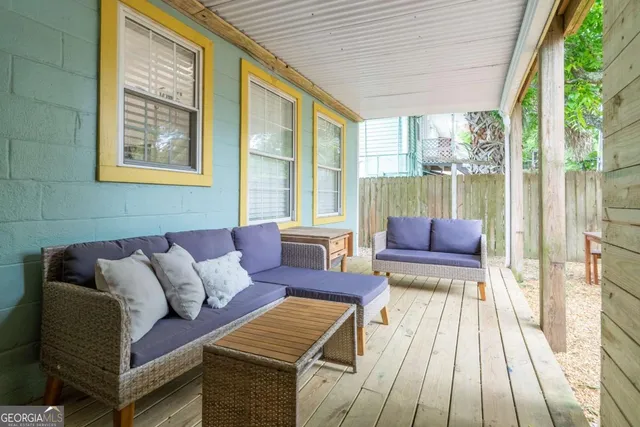 a view of a patio with table and chairs and wooden floor