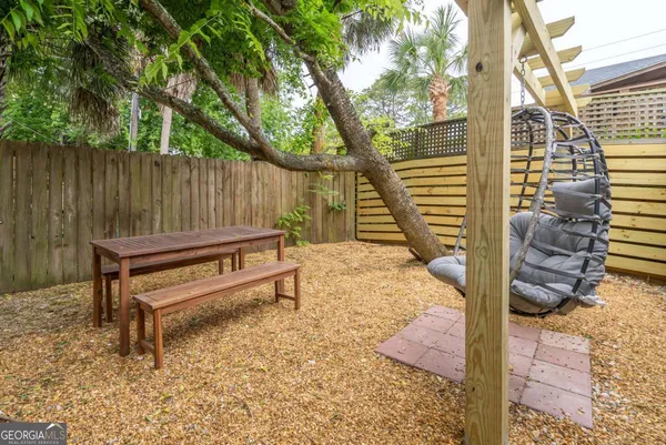 a backyard of a house with table and chairs