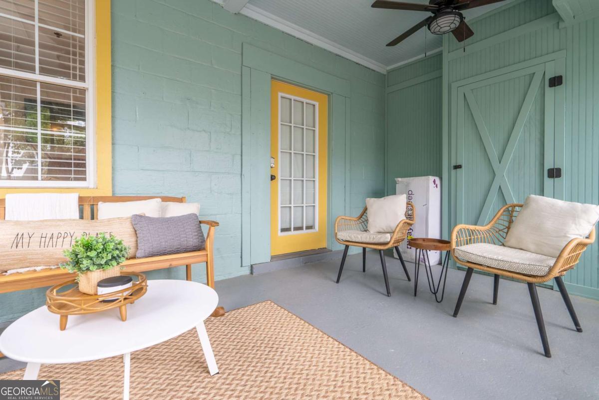 1413 2nd Avenue, Unit 4 Tybee Island, GA 31328 - Photo 7 of 32 a living room with furniture and a potted plant