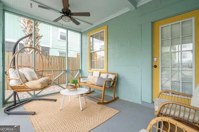 a living room with furniture and floor to ceiling windows