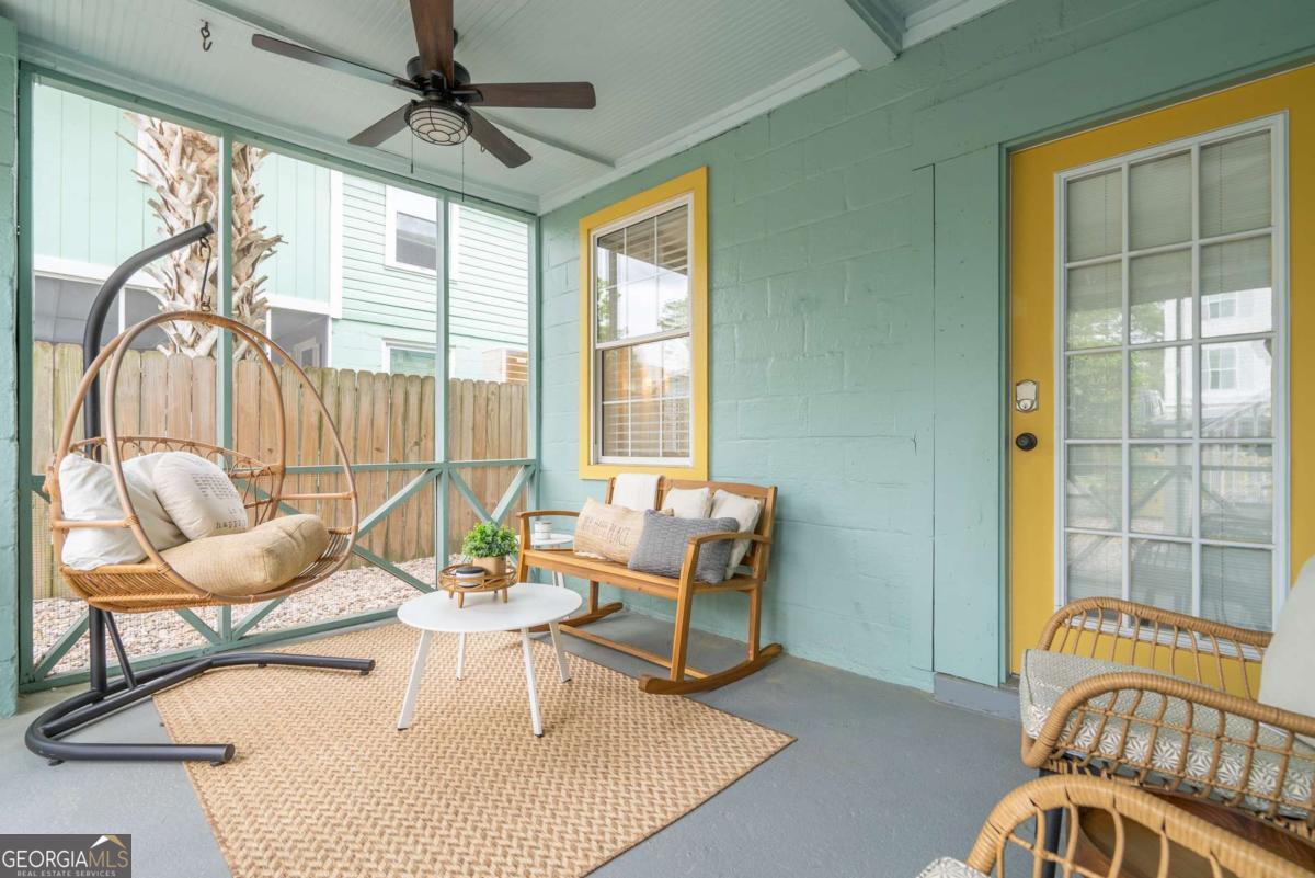 1413 2nd Avenue, Unit 4 Tybee Island, GA 31328 - Photo 8 of 32 a living room with furniture and floor to ceiling windows