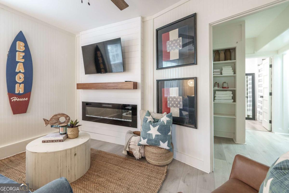 1413 2nd Avenue, Unit 4 Tybee Island, GA 31328 - Photo 10 of 32 a living room with furniture and a fireplace