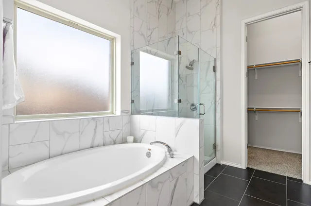 a bathroom with a bathtub and shower