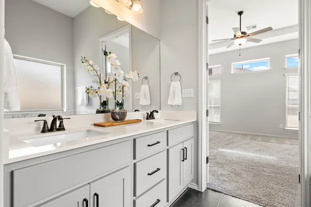 a bathroom with a double vanity sink mirror and