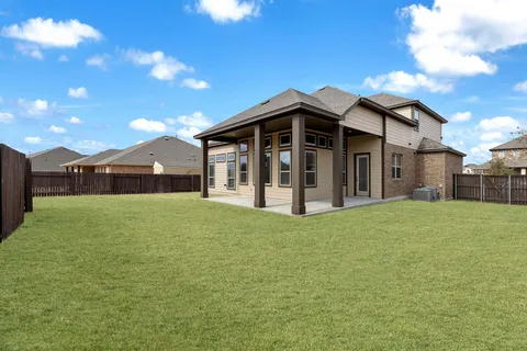 a view of a house with a backyard