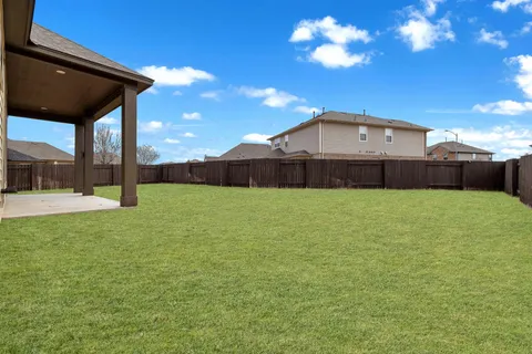 a view of a house with a backyard