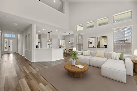 a living room with furniture and a wooden floor