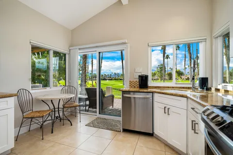 a kitchen with a sink and chairs