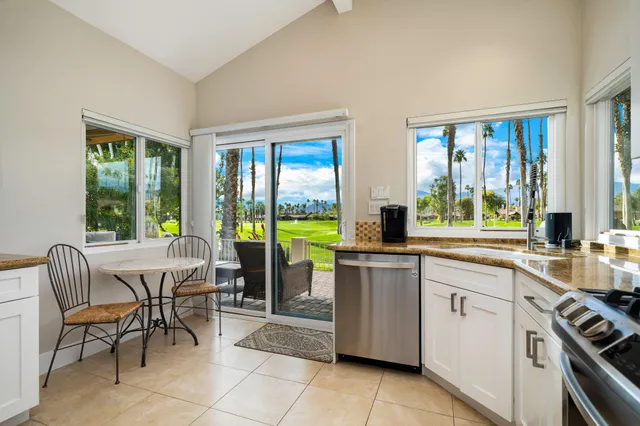a kitchen with a sink and chairs