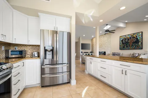 a kitchen with stainless steel appliances a refrigerator sink and cabinets