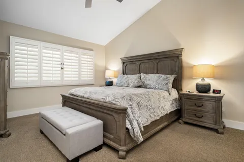 a bedroom with a bed and a night stand