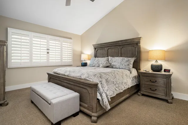 a bedroom with a bed and a night stand