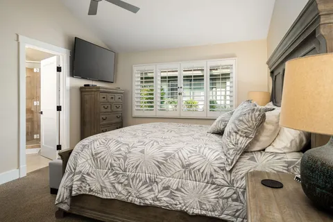 a bedroom with a bed and a television